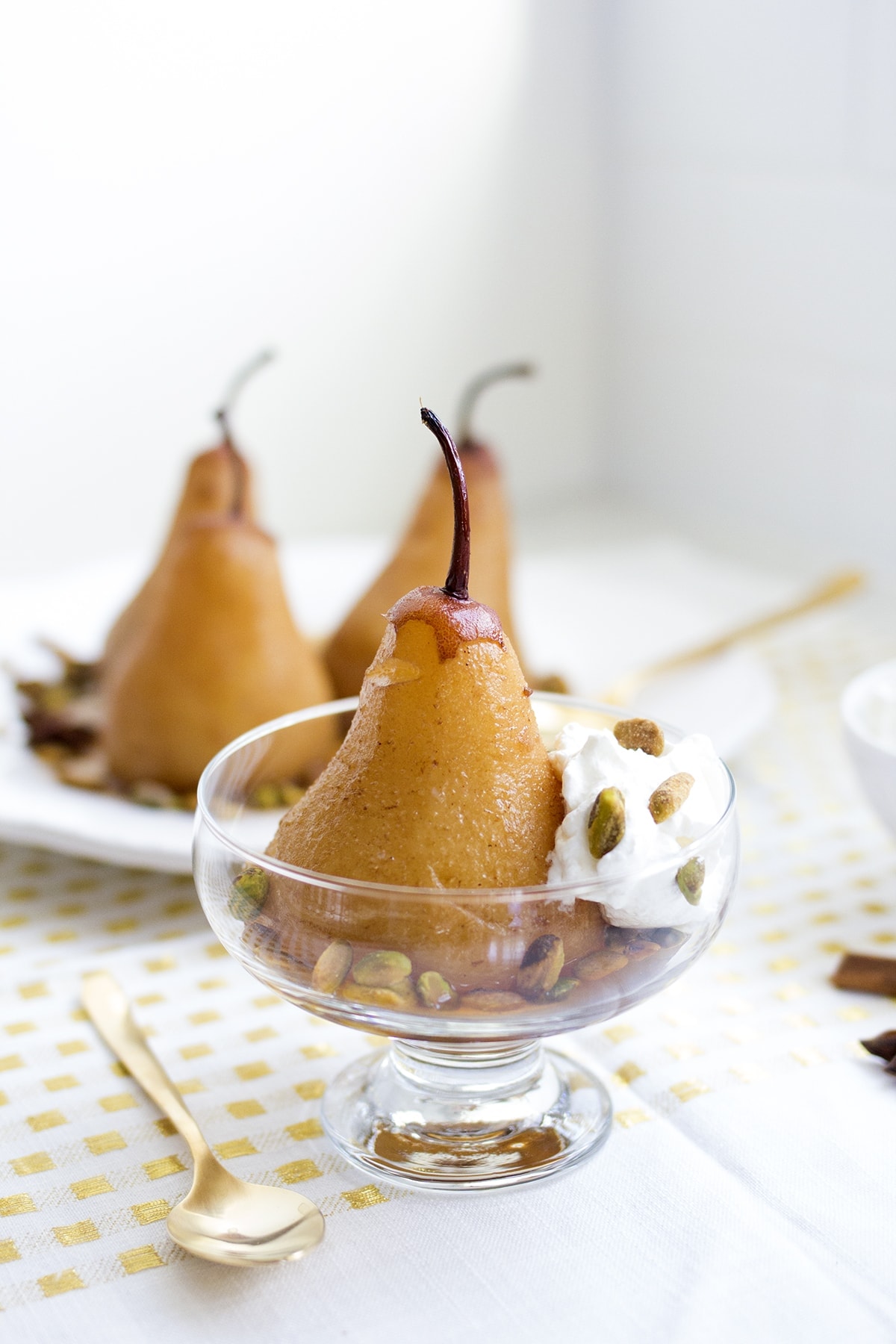 Chai Poached Pears with Whipped Cream and Pistachios