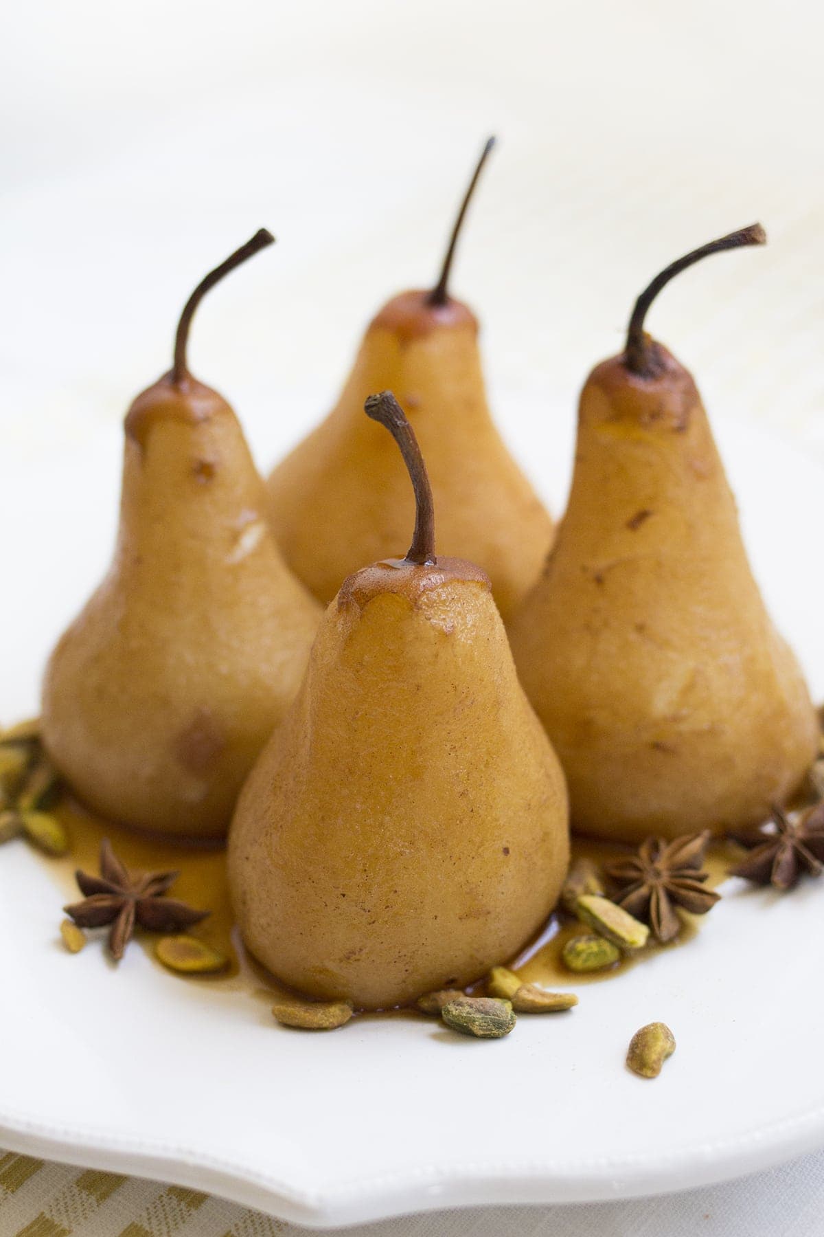 Chai Poached Pears with Whipped Cream and Pistachios