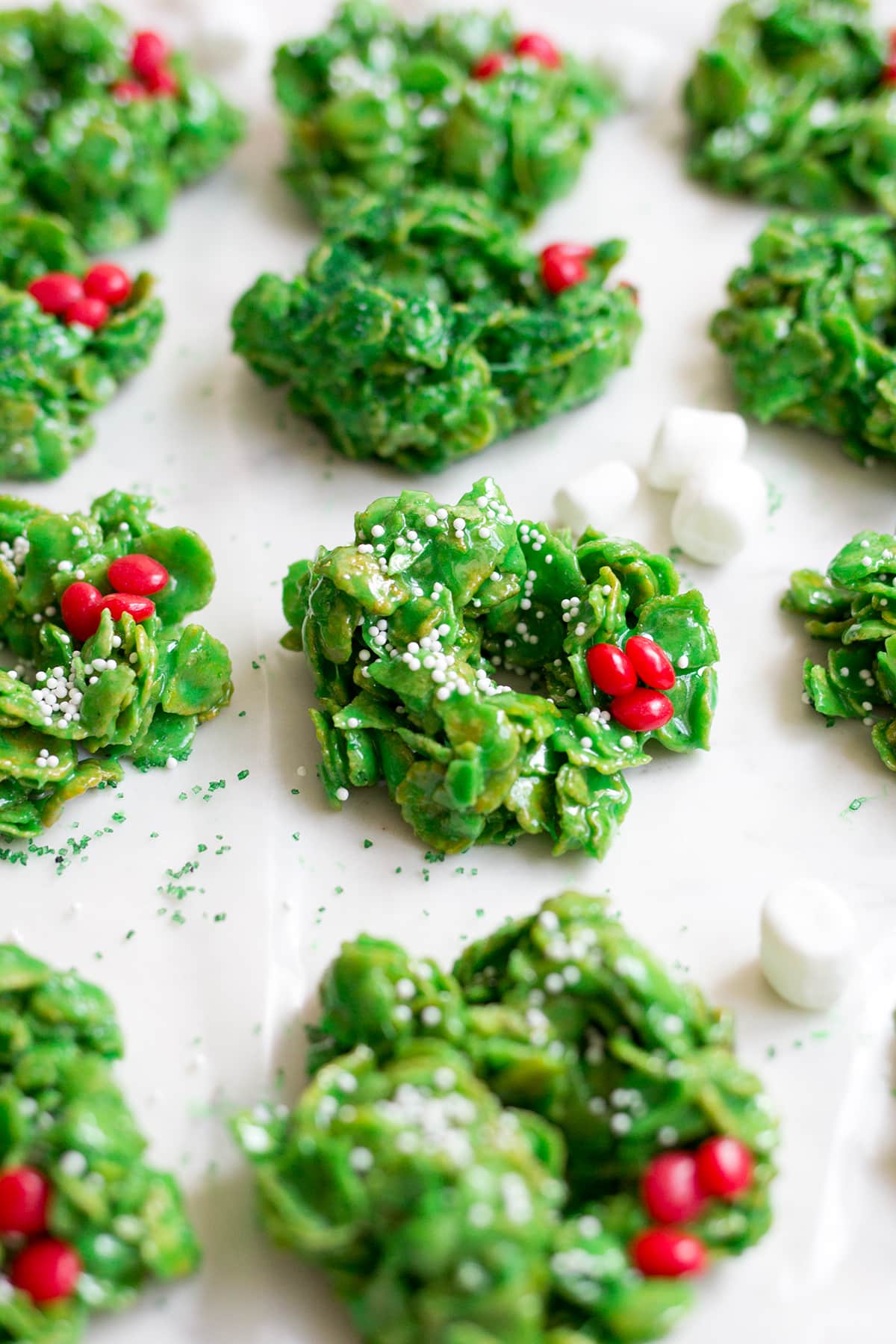 Classic Christmas Wreath Cookies, also known as holly wreath cookies, made with corn flakes and cinnamon candies are perfect for making with kids and leaving out for Santa on Christmas Eve.