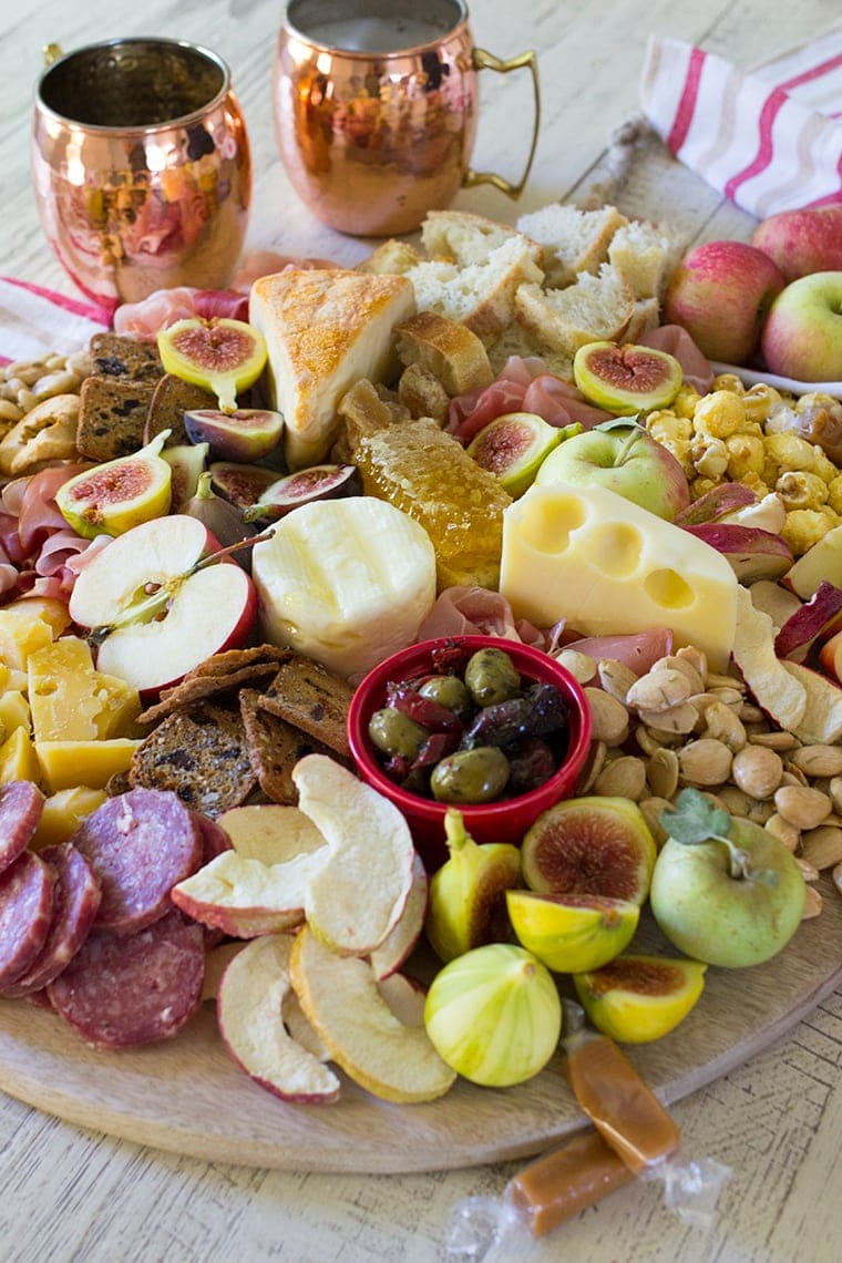 Fall Harvest Apple Inspired Cheese Board is a great party appetizer board to enjoy with friends and a bottle of crisp hard apple cider. I’m sharing all of my easy fall cheese board display ideas and Trader Joe’s ingredient list. #cheeseboardIdeas #DIYcheeseboard #cheeseboarddisplay #cheeseboardrecipes #easycheeseboard #traderjoes #fall #holiday #howtomakea #wooden #fall #harvest #apple #cheeseboard #traderjoescheeseboard #fallcheeseboard 