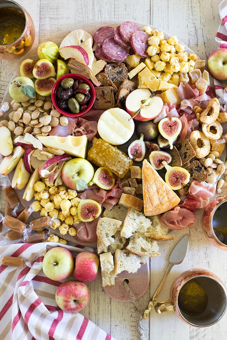 Fall Harvest Apple Inspired Cheese Board is a great party appetizer board to enjoy with friends and a bottle of crisp hard apple cider. I’m sharing all of my easy fall cheese board display ideas and Trader Joe’s ingredient list. #cheeseboardIdeas #DIYcheeseboard #cheeseboarddisplay #cheeseboardrecipes #easycheeseboard #traderjoes #fall #holiday #howtomakea #wooden #fall #harvest #apple #cheeseboard #traderjoescheeseboard #fallcheeseboard