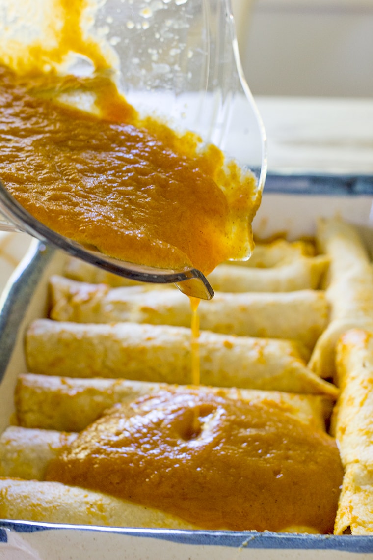 Pumpkin Chicken Enchiladas with a Pumpkin Enchilada Sauce make an easy and delicious family weeknight or weekend dinner perfect for fall. #enchiladas #pumpkin #chickenenchiladas #pumpkinenchiladas #enchiladasauce #glutenfree #glutenfreeenchiladas #pumpkinspice #dinner #weeknightdinner #easydinner #rotisseriechicken