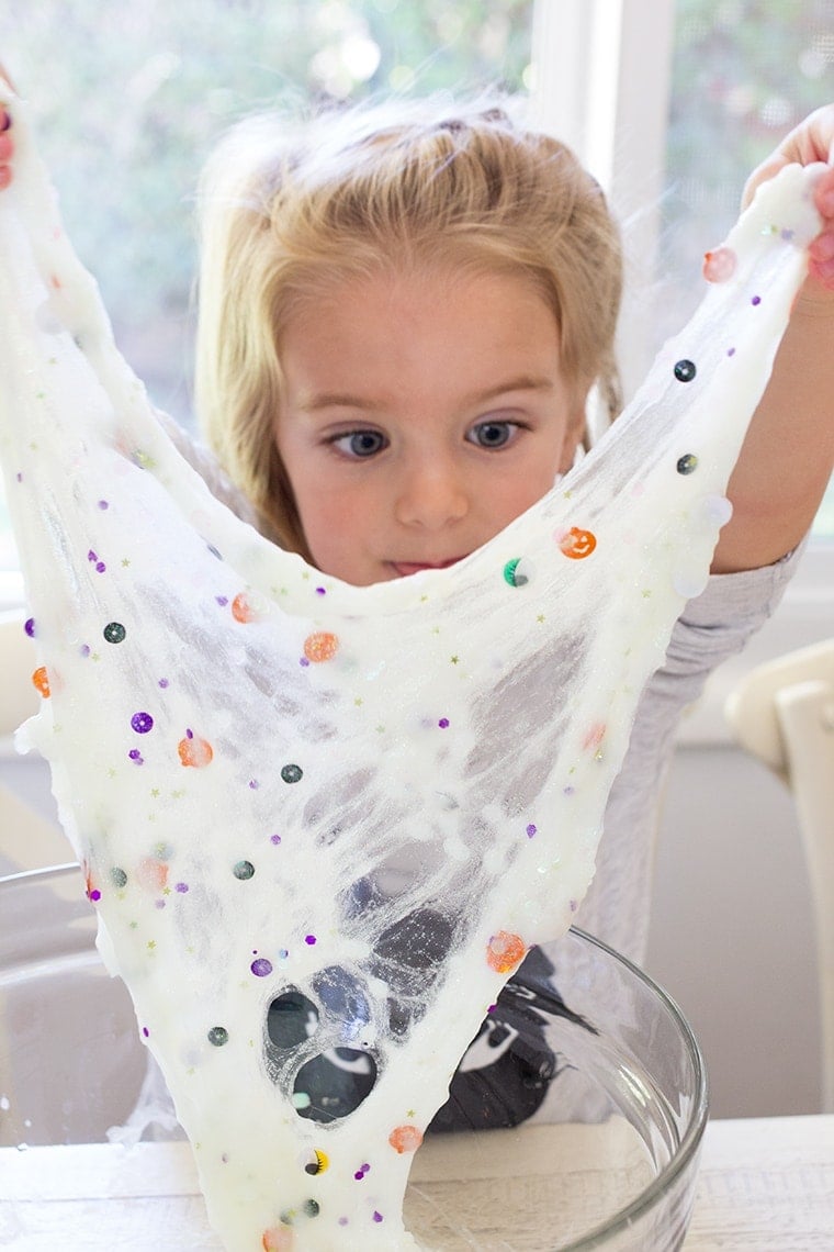 Toddler Safe Halloween Glitter Slime Recipe only has 3 Ingredients and no Borax so it's worry free for kids. Great for sensory play, preschool, or kindergarten classrooms. Mess free and quick to make for ages 3 and up. #Slime #BakingSoda #Glue #ContactLenses #Goo #Solutions #Glitter #Magic #Craft #Kids #KidsCraft #SlimeRecipe #Diy #Activities #KidsStuff