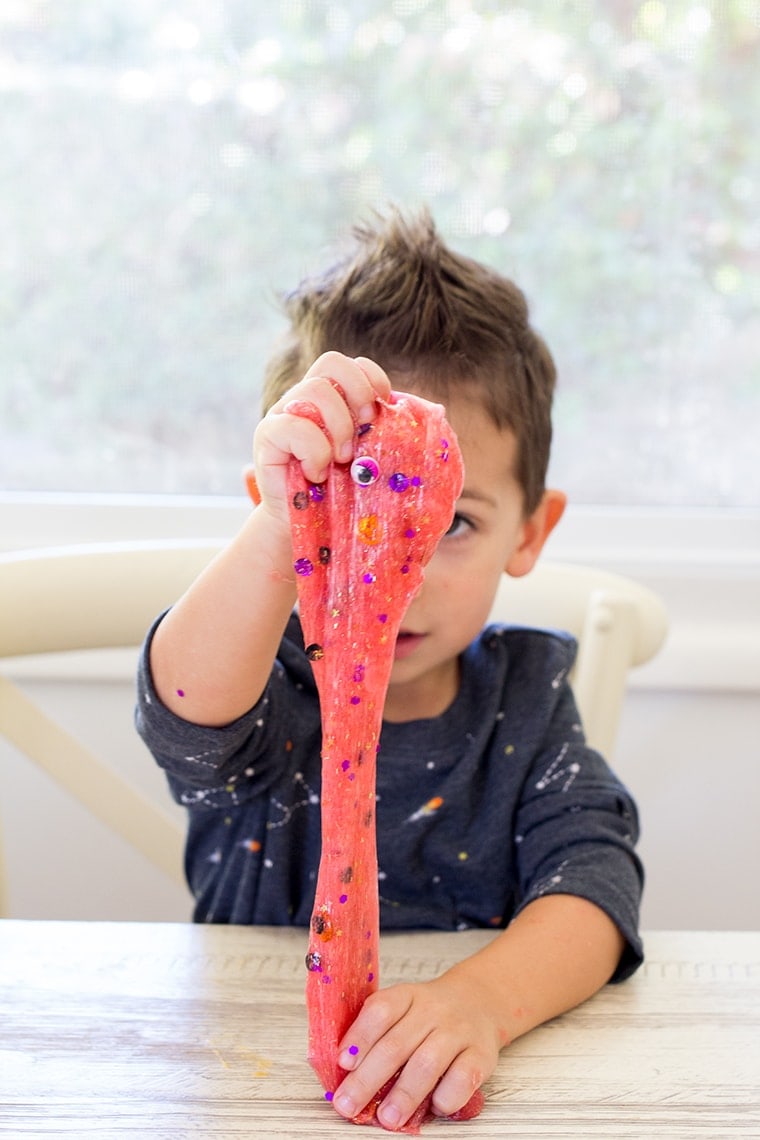 Toddler Safe Halloween Glitter Slime Recipe only has 3 Ingredients and no Borax so it's worry free for kids. Great for sensory play, preschool, or kindergarten classrooms. Mess free and quick to make for ages 3 and up. #Slime #BakingSoda #Glue #ContactLenses #Goo #Solutions #Glitter #Magic #Craft #Kids #KidsCraft #SlimeRecipe #Diy #Activities #KidsStuff