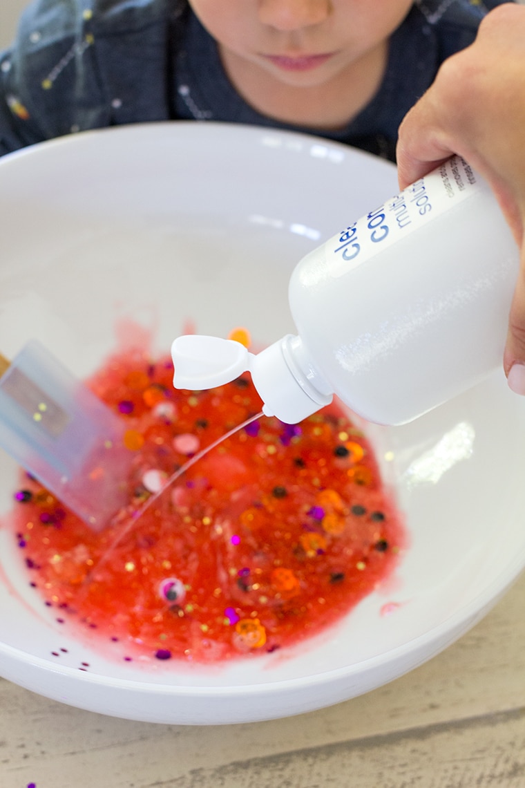 Toddler Safe Halloween Glitter Slime Recipe only has 3 Ingredients and no Borax so it's worry free for kids. Great for sensory play, preschool, or kindergarten classrooms. Mess free and quick to make for ages 3 and up. #Slime #BakingSoda #Glue #ContactLenses #Goo #Solutions #Glitter #Magic #Craft #Kids #KidsCraft #SlimeRecipe #Diy #Activities