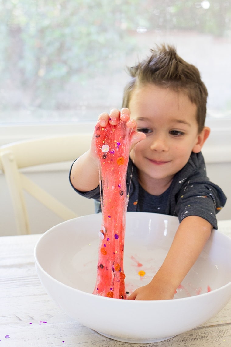 Toddler Safe Halloween Glitter Slime Recipe only has 3 Ingredients and no Borax so it's worry free for kids. Great for sensory play, preschool, or kindergarten classrooms. Mess free and quick to make for ages 3 and up. #Slime #BakingSoda #Glue #ContactLenses #Goo #Solutions #Glitter #Magic #Craft #Kids #KidsCraft #SlimeRecipe #Diy #Activities