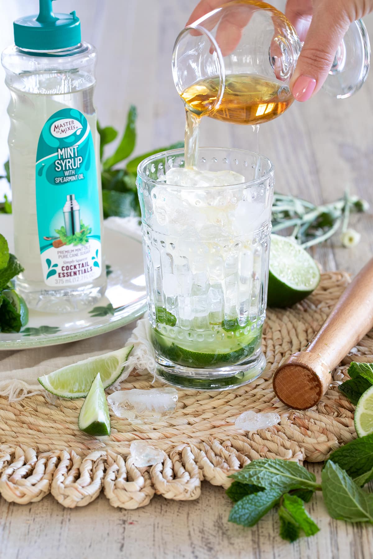 Irish Mint Mojitos are the perfect St. Patrick's Day cocktail made with Irish Whiskey, Mint Simple Syrup, muddled mint and limes and topped with club soda. #stpatricksday #mojito #whiskeycocktail #irishmojito