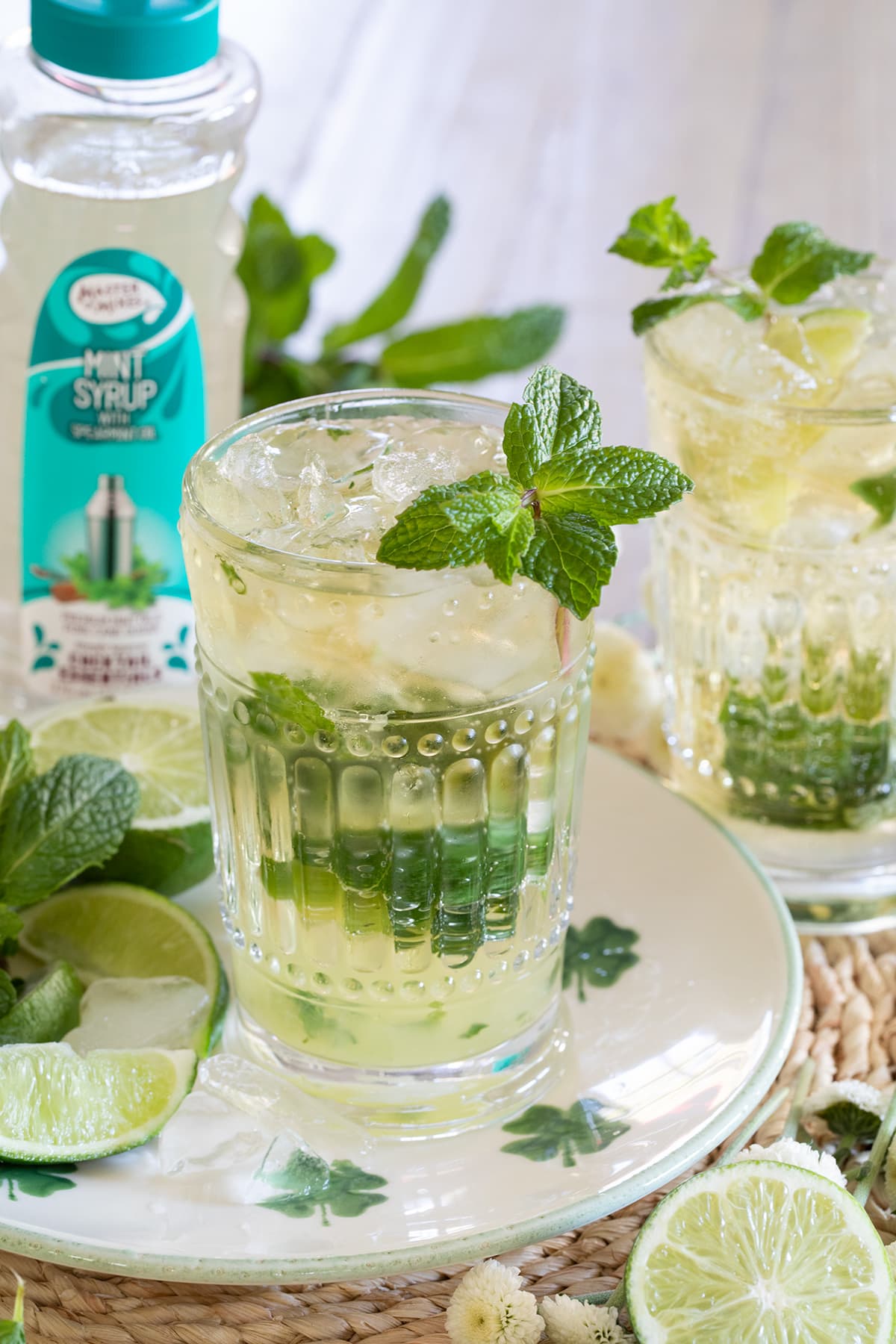 Irish Mint Mojitos are the perfect St. Patrick's Day cocktail made with Irish Whiskey, Mint Simple Syrup, muddled mint and limes and topped with club soda. #stpatricksday #mojito #whiskeycocktail #irishmojito