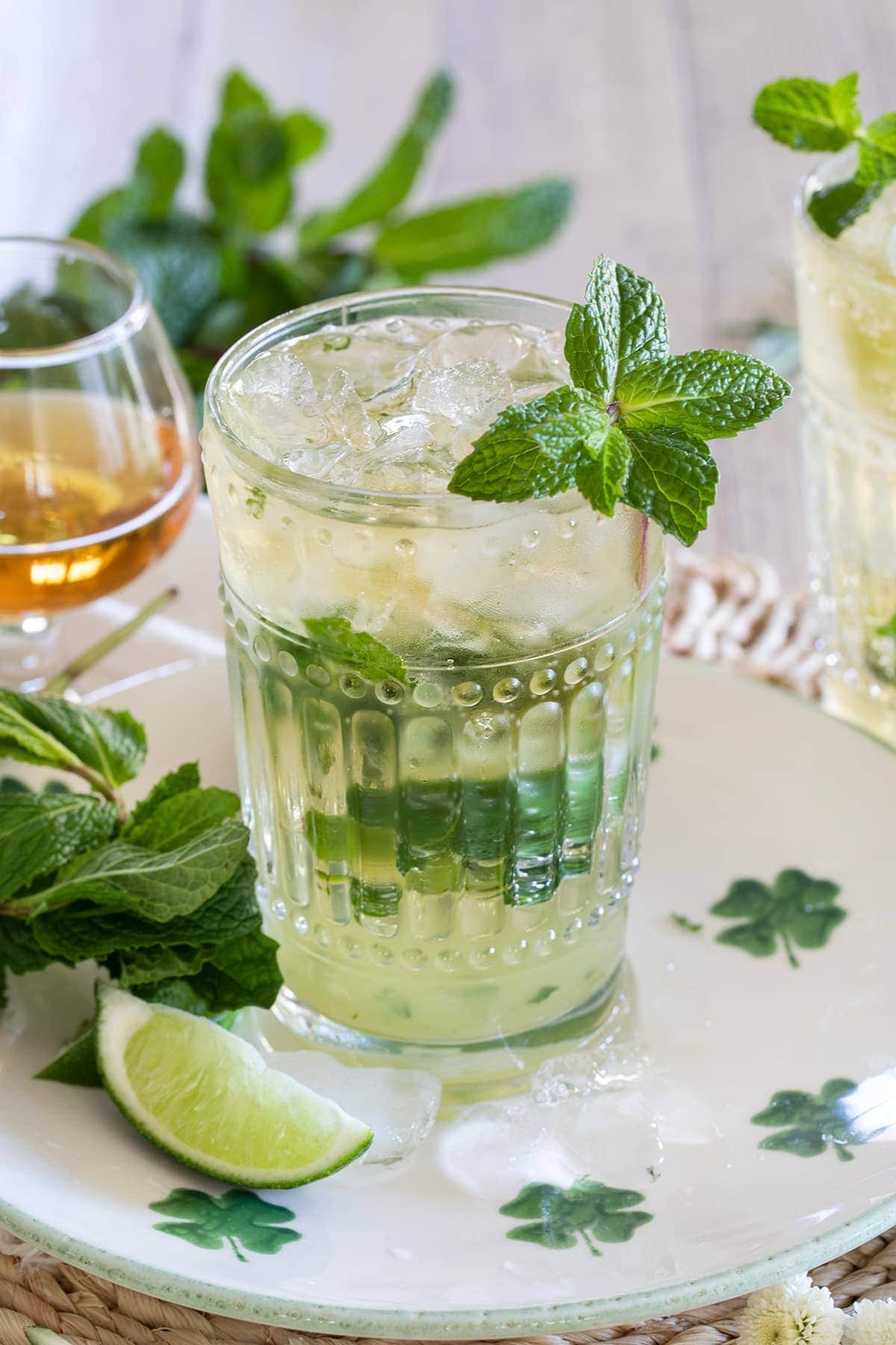 Irish Mint Mojitos are the perfect St. Patrick's Day cocktail made with Irish Whiskey, Mint Simple Syrup, muddled mint and limes and topped with club soda. 