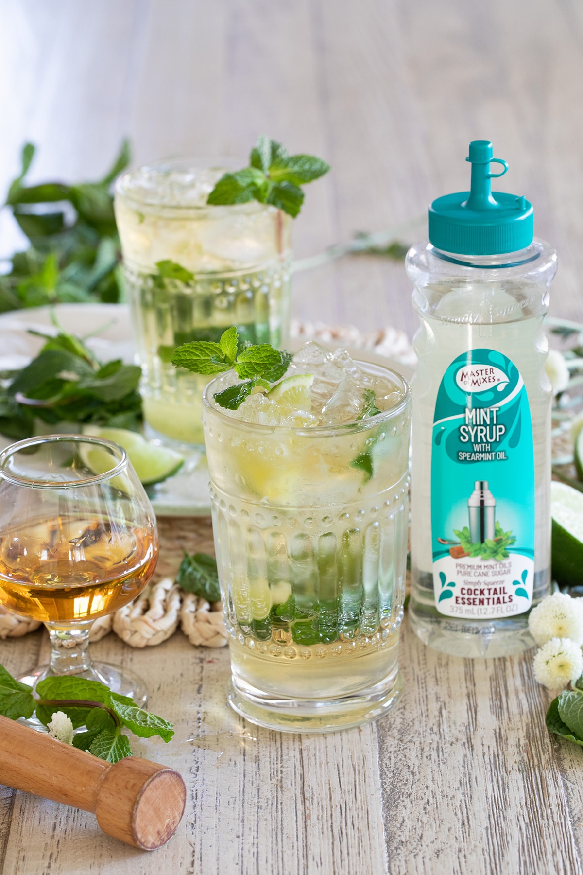Irish Mint Mojitos are the perfect St. Patrick's Day cocktail made with Irish Whiskey, Mint Simple Syrup, muddled mint and limes and topped with club soda. #stpatricksday #mojito #whiskeycocktail #irishmojito