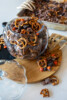 Halloween Muddy Buddies with chocolate-coated Rice Chex, mini pretzels, Mini Oreos, and orange and black M&M's party mix.